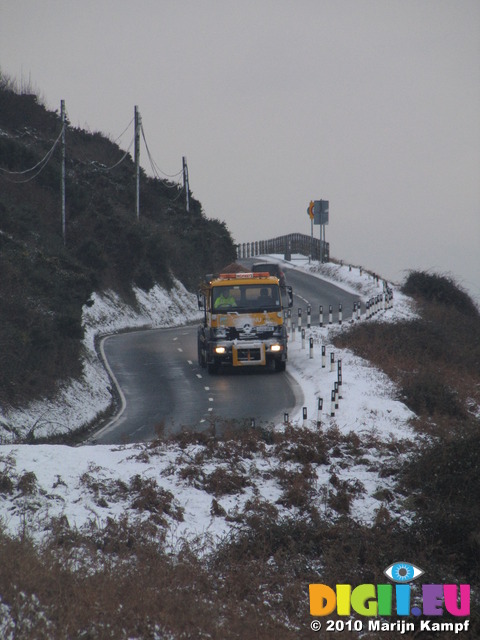 SX12143 Gritting truck driving through hillsides covered in snow